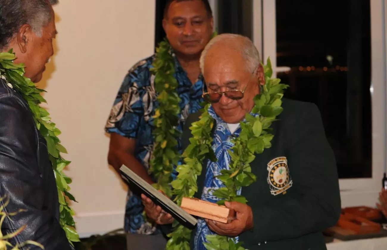 Tutai Toru receives his pioneer award from Prime Minister Henry Puna with King's Representative, His Excellency Sir Tom Marsters in the background, August 2019.